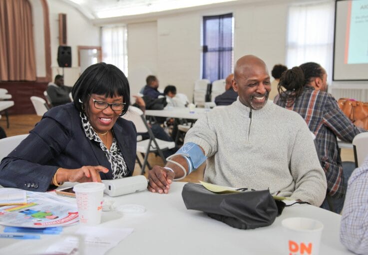 This image shows community volunteers working at a blood draw event.