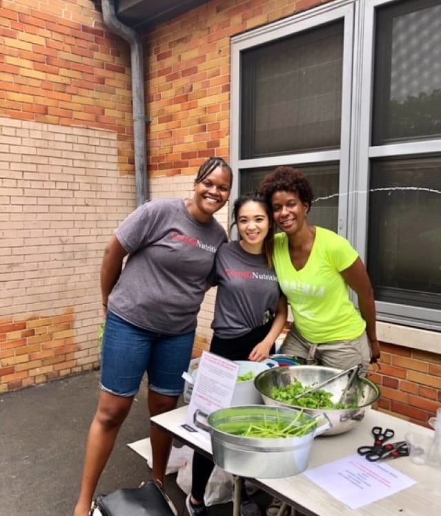 This image shows volunteers working at a community food event.